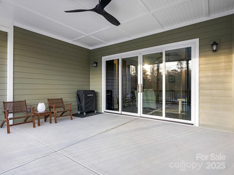 Screened-in porch, quad sliding doors, and ceiling fan