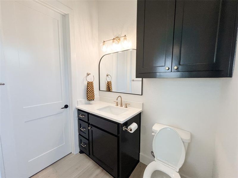 Bathroom featuring vanity and light wood-style floors