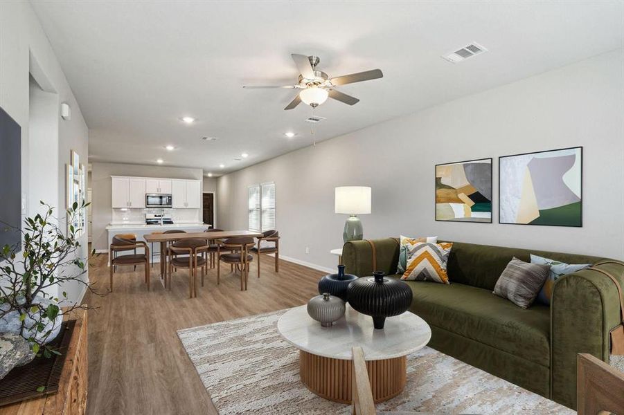 Living area with a ceiling fan, recessed lighting, and light wood-type flooring