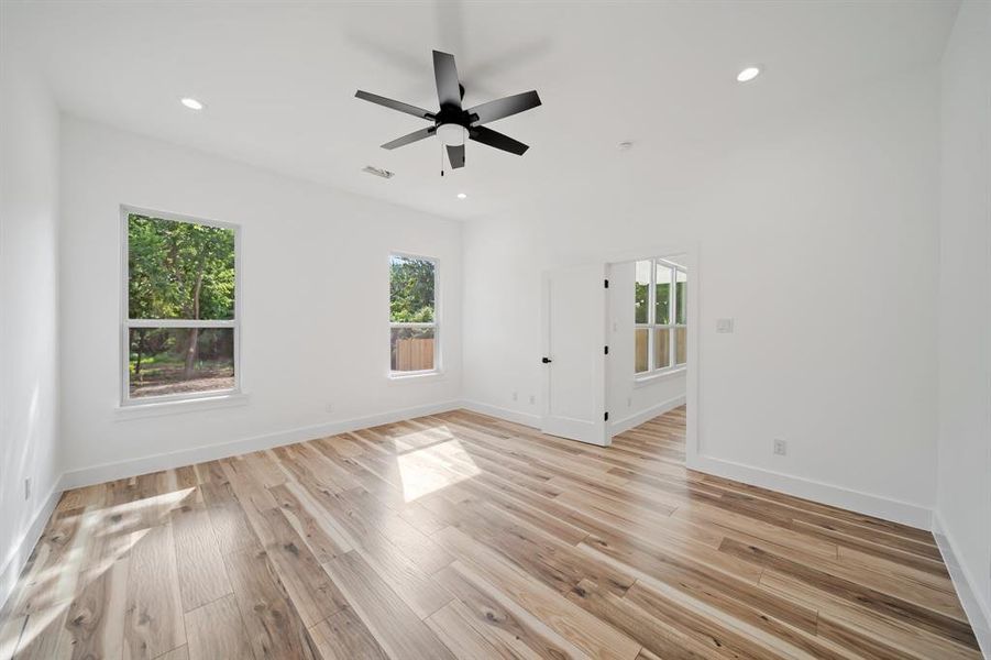 Empty room featuring light wood-type flooring and ceiling fan