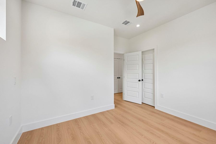 Blonde wood look flooring and bright white walls create a clean, modern aesthetic. Blonde wood look flooring and bright white walls create a clean, modern aesthetic.