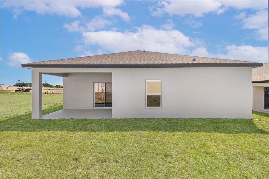 Front exterior of a new home in Peach Crossings, Winter Haven, FL, highlighting curb appeal (Image 1).
