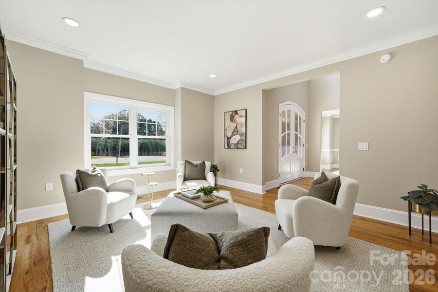 Stylish front living room with designer seating and abundant natural light. Stylish front living room with designer seating and abundant natural light.