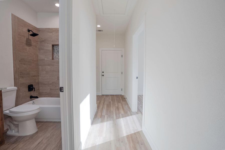 Hall with attic access, light wood finished floors, and recessed lighting Hall with attic access, light wood finished floors, and recessed lighting