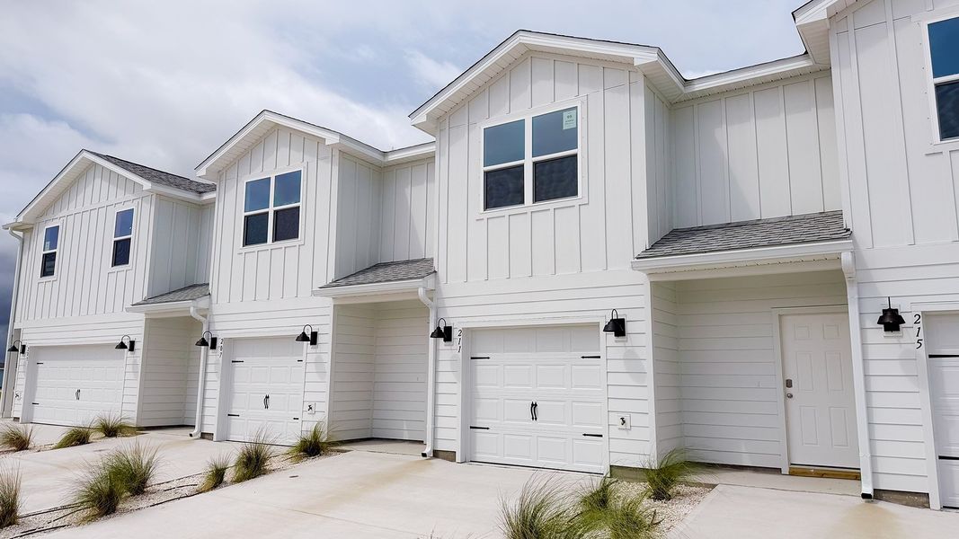 Front exterior of a new home in Salt Creek Townhomes at Mexico Beach, Mexico Beach, FL, highlighting curb appeal (Image 19). Front exterior of a new home in Salt Creek Townhomes at Mexico Beach, Mexico Beach, FL, highlighting curb appeal (Image 19).