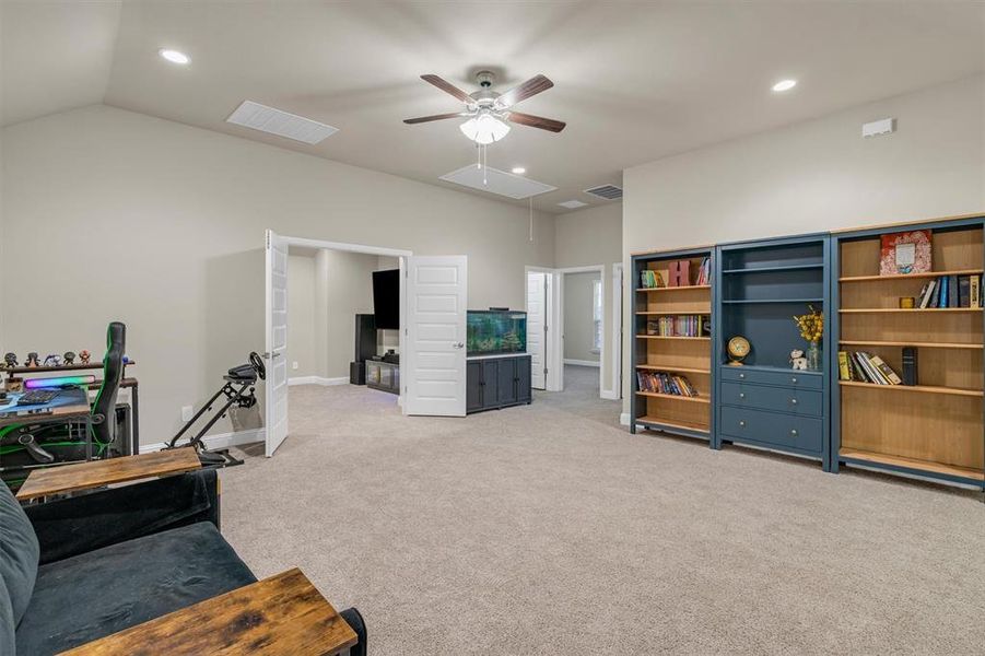 Sitting room featuring light carpet, a ceiling fan, recessed lighting, and lofted ceiling