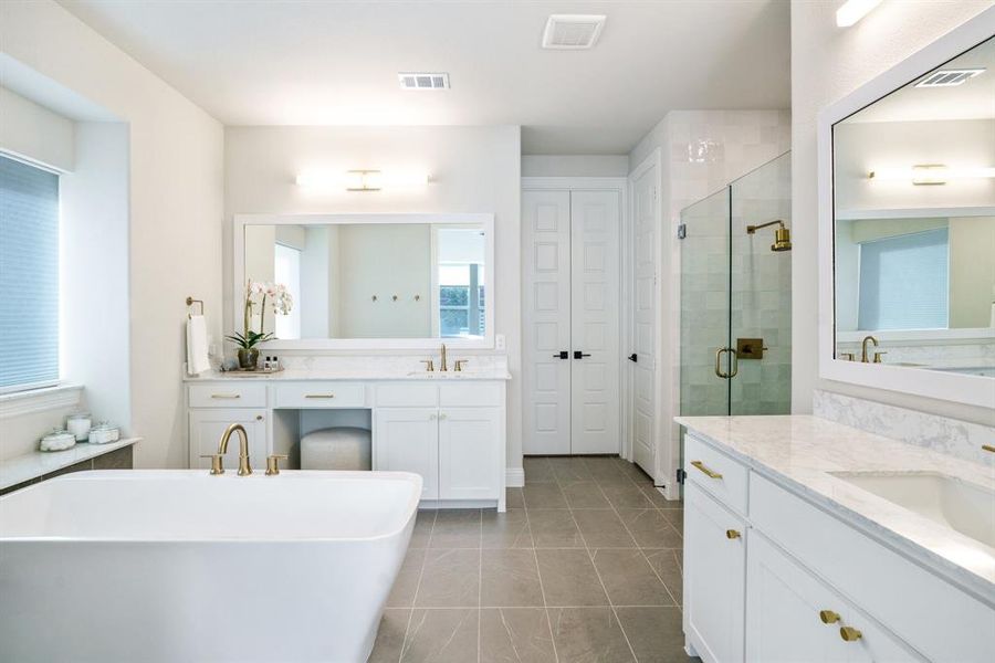 Luxe Spa Experience - Quartz counters, brass fixtures, and a freestanding soaking tub set the tone for relaxation. Dual vanities and custom lighting elevate the everyday routine. Luxe Spa Experience - Quartz counters, brass fixtures, and a freestanding soaking tub set the tone for relaxation. Dual vanities and custom lighting elevate the everyday routine.