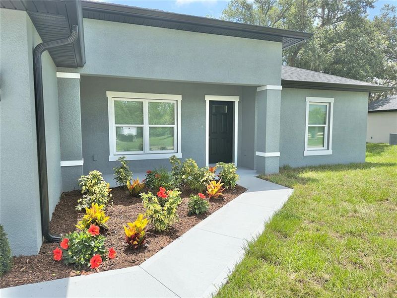 Front exterior of a new home in , Port Charlotte, FL, highlighting curb appeal (Image 23).