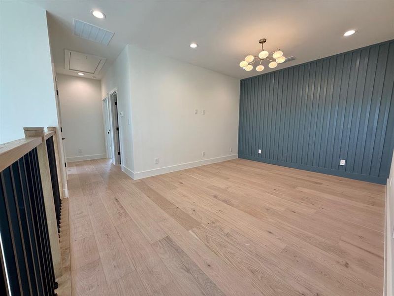 Upstairs living or loft area with accent wall