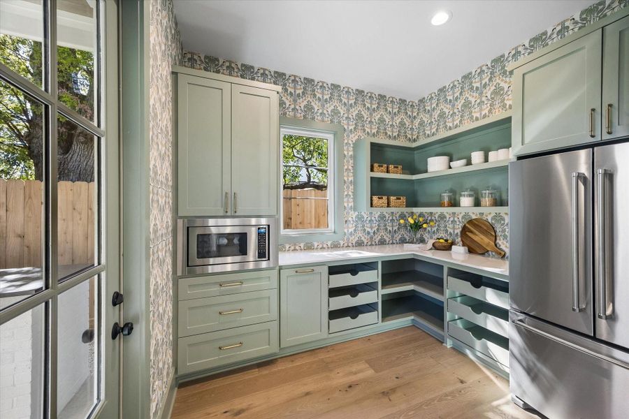 Custom walk in pantry featuring floor to ceiling cabinetry, built in drawer storage, open shelving, and designer wallpaper accents, offering abundant organization and prep space to complement the chef’s kitchen in this thoughtfully crafted Harvard Homes design.**PREVIOUS BUILDER WORK** Custom walk in pantry featuring floor to ceiling cabinetry, built in drawer storage, open shelving, and designer wallpaper accents, offering abundant organization and prep space to complement the chef’s kitchen in this thoughtfully crafted Harvard Homes design.**PREVIOUS BUILDER WORK**