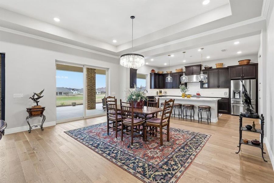 Perfectly situated between the Great Room and Gourmet Cook’s Kitchen, this Refined Dining Space features its own Double Sliding Glass Doors and Effortless Access to the Outdoor Pavilion Designed for Seamless Entertaining and offers an Elegant Setting for both Intimate Dinners and Grand Gatherings.