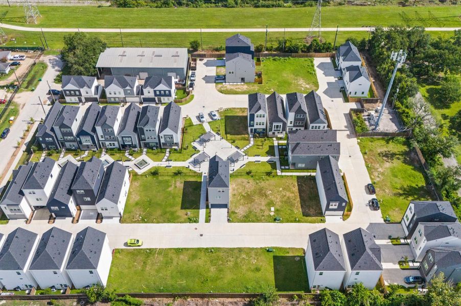 Showcasing the full scope of the neighborhood, this stunning aerial view captures the community’s thoughtful layout, lush green spaces, and inviting shared amenities. This bird’s-eye perspective highlights the seamless blend of architecture and nature. Ideal for getting a true sense of scale, proximity, and lifestyle, this elevated view paints a vivid picture of what it means to live here. Showcasing the full scope of the neighborhood, this stunning aerial view captures the community’s thoughtful layout, lush green spaces, and inviting shared amenities. This bird’s-eye perspective highlights the seamless blend of architecture and nature. Ideal for getting a true sense of scale, proximity, and lifestyle, this elevated view paints a vivid picture of what it means to live here.