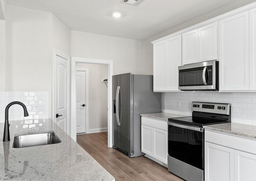 The kitchen of the Cypress has sprawling granite countertops.