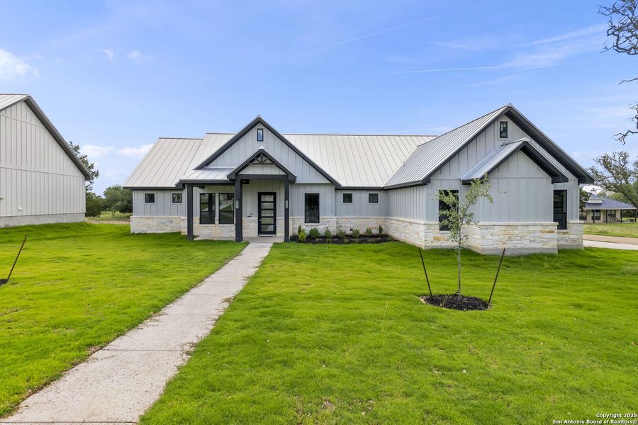 Front exterior of a new home in , Wimberley, TX, highlighting curb appeal (Image 1).