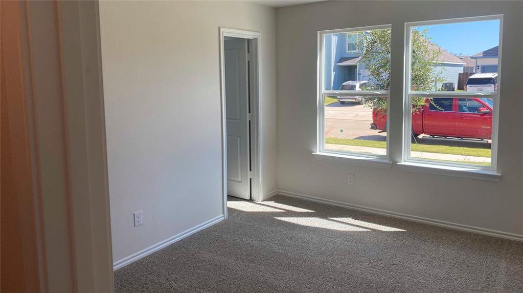 Unfurnished room featuring light colored carpet and baseboards