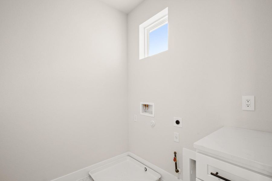 Laundry area featuring gas dryer hookup, hookup for a washing machine, and electric dryer hookup