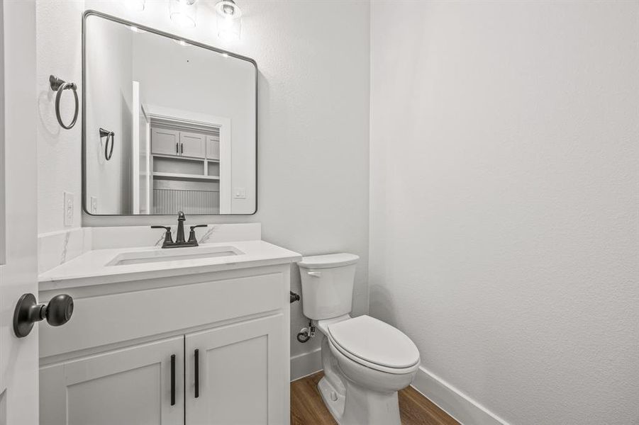 Bathroom featuring wood finished floors and vanity Bathroom featuring wood finished floors and vanity