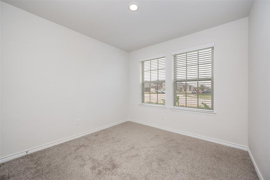Carpeted empty room with baseboards and recessed lighting