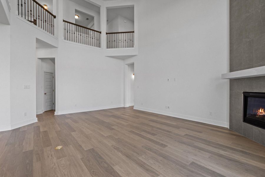 Family Room with soaring ceiling & fireplace