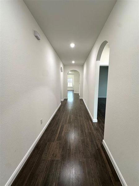 Corridor with dark hardwood / wood-style flooring