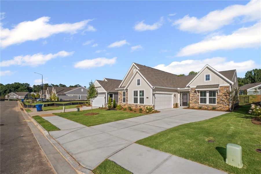 Front exterior of a new home in Laurel Farms, Dallas, GA, highlighting curb appeal (Image 24). Front exterior of a new home in Laurel Farms, Dallas, GA, highlighting curb appeal (Image 24).