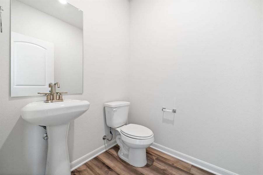 Bathroom featuring hardwood / wood-style flooring and toilet