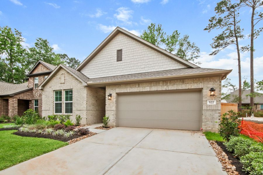 Front exterior of a new home in The Woodlands Hills, Willis, TX, highlighting curb appeal (Image 2). Front exterior of a new home in The Woodlands Hills, Willis, TX, highlighting curb appeal (Image 2).