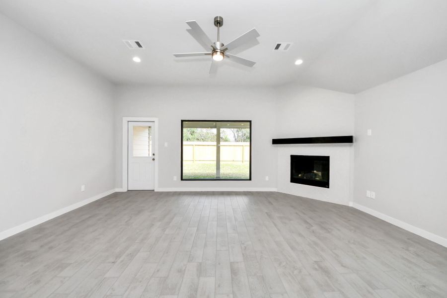 Gather the family and guests together in your lovely living room! Featuring soaring high ceilings, recessed lighting, ceiling fan, custom paint, gorgeous floors, and a large window that provide plenty of natural lighting throughout the day. Sample photo of completed home with similar floor plan. Actual colors and selections may vary. Gather the family and guests together in your lovely living room! Featuring soaring high ceilings, recessed lighting, ceiling fan, custom paint, gorgeous floors, and a large window that provide plenty of natural lighting throughout the day. Sample photo of completed home with similar floor plan. Actual colors and selections may vary.