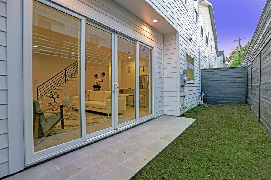 Inviting backyard with an extended patio perfect for relaxation and entertainment.