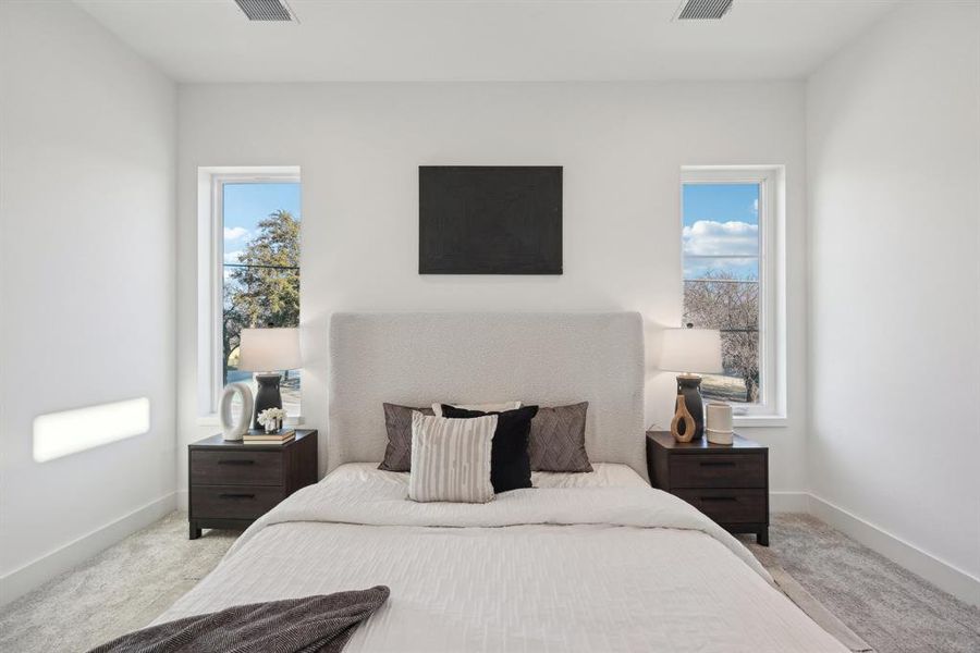 Bedroom featuring light carpet