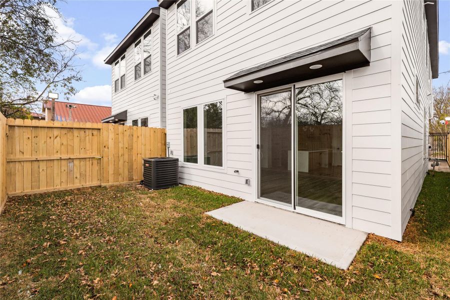 Private fenced backyard with a patio area and sliding door access—great for outdoor living.