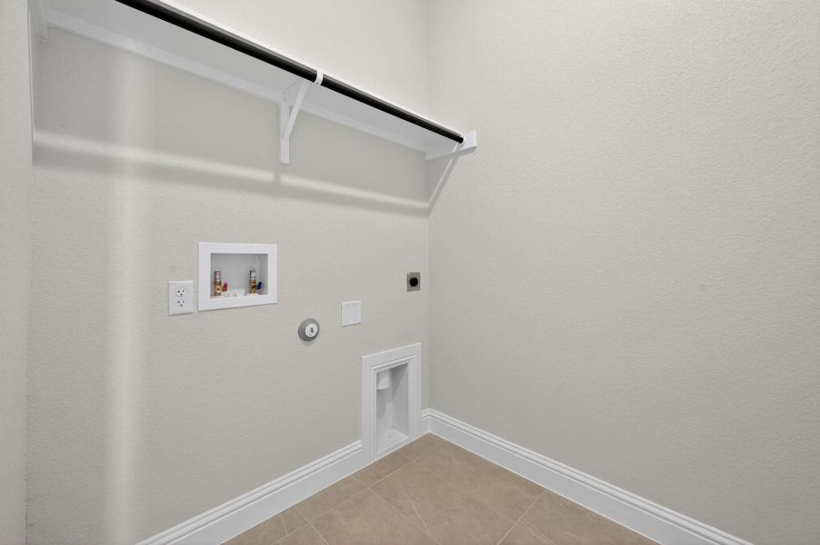 Laundry room featuring light tile patterned flooring, washer hookup, hookup for an electric dryer, and gas dryer hookup