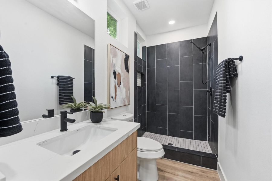 Updated, full-size bath with walk-in shower in the studio apartment.