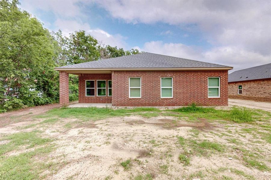 Rear view of property featuring a patio area