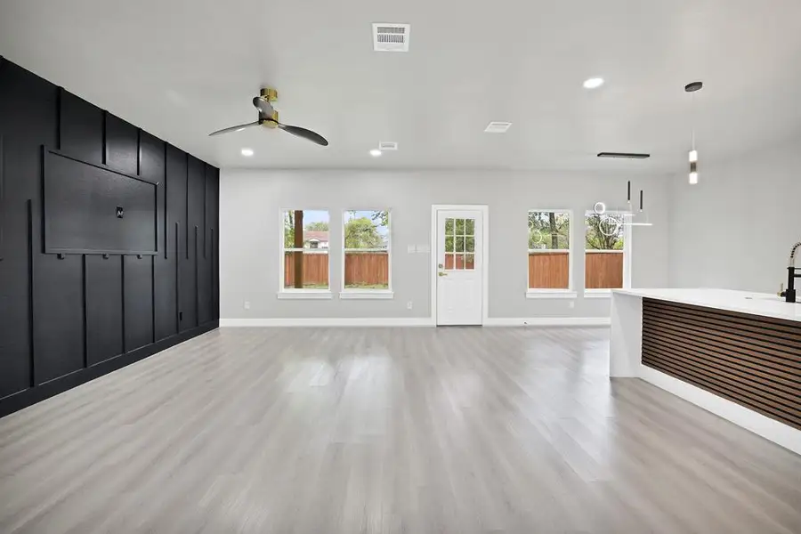 Unfurnished living room with ceiling fan and light hardwood / wood-style floors