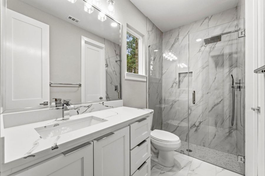 Ceramic tile throughout shower, oversized showerhead and custom finishes.