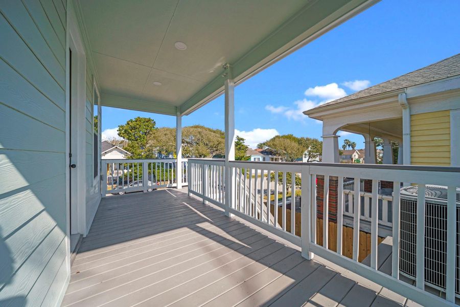 This photo showcases a spacious, covered balcony with white railings and a view of nearby houses and greenery, perfect for enjoying outdoor relaxation. This photo showcases a spacious, covered balcony with white railings and a view of nearby houses and greenery, perfect for enjoying outdoor relaxation.