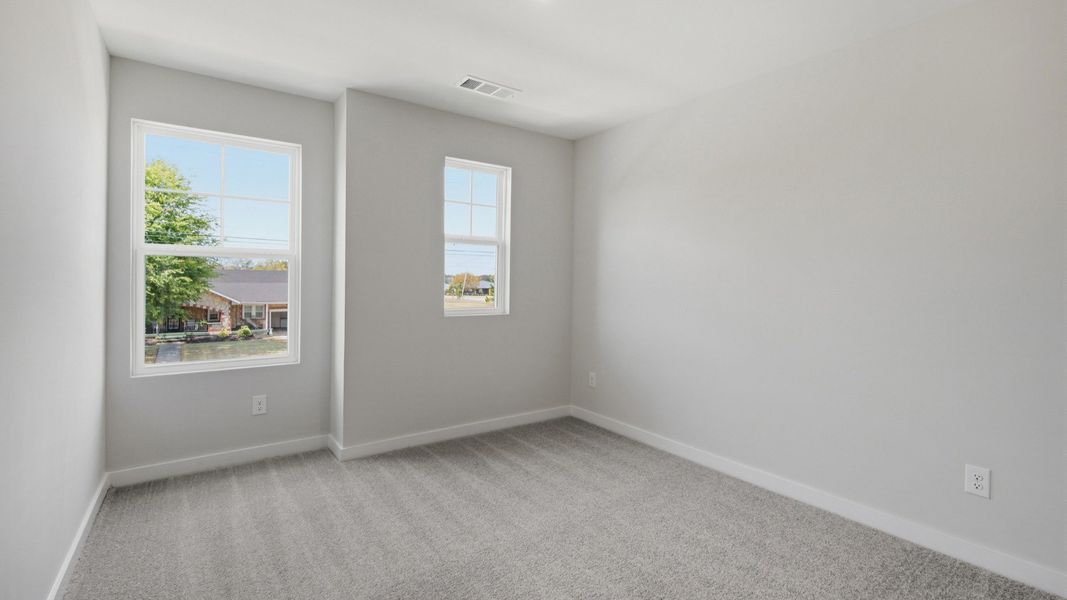 Secondary bedroom with upstairs view of community