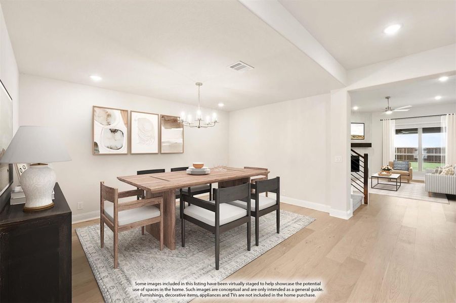 Dining room with wood table, six chairs, chandelier, and light hardwood floors open to living area