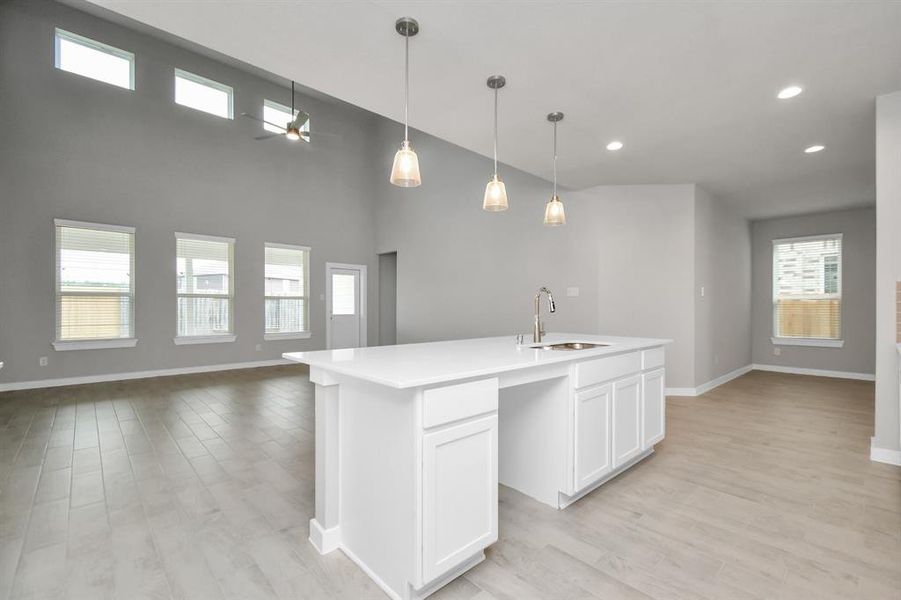 View of the family from from the kitchen. Sample photo of completed home with similar plan. As built color and selections may vary.