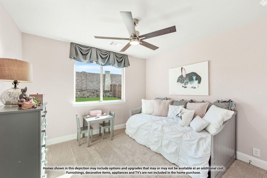 Children's bedroom with daybed, ceiling fan, pink walls, and small play table and chairs Children's bedroom with daybed, ceiling fan, pink walls, and small play table and chairs