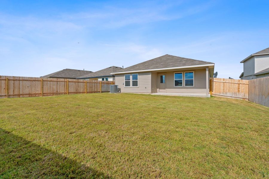 Back of house with a patio area, a fenced backyard, and roof with shingles Back of house with a patio area, a fenced backyard, and roof with shingles