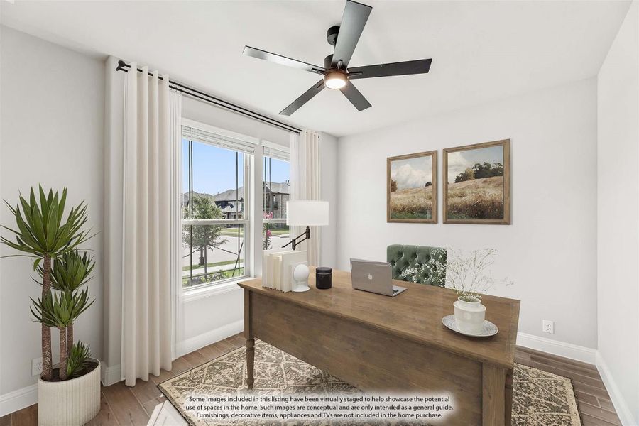 Home office with wood desk, ceiling fan, hardwood floors, and large window with natural light