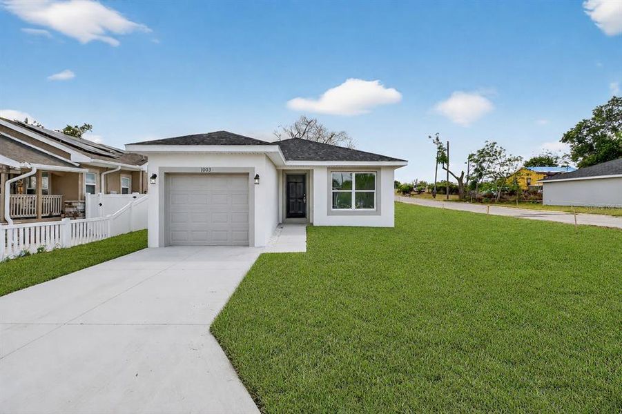 Front exterior of a new home in , Haines City, FL, highlighting curb appeal (Image 1). Front exterior of a new home in , Haines City, FL, highlighting curb appeal (Image 1).