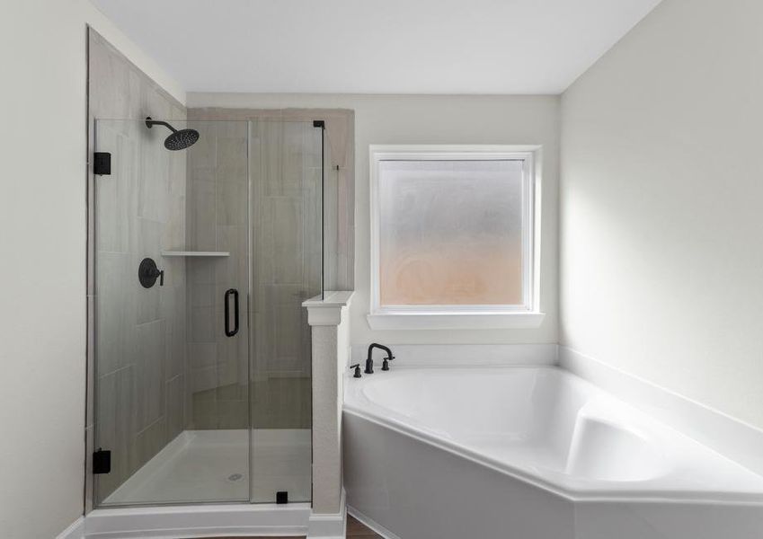 Master bathroom with a large vanity and a step in shower and soaking tub