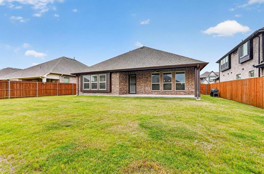 Expansive backyard featuring a lush lawn and a covered patio Expansive backyard featuring a lush lawn and a covered patio