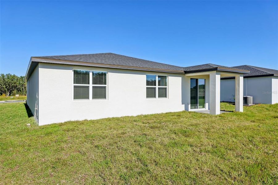 Exterior details and patio area of a home in The Reserve at Hammock Oaks - Signature Series, Lady Lake (Image 23).