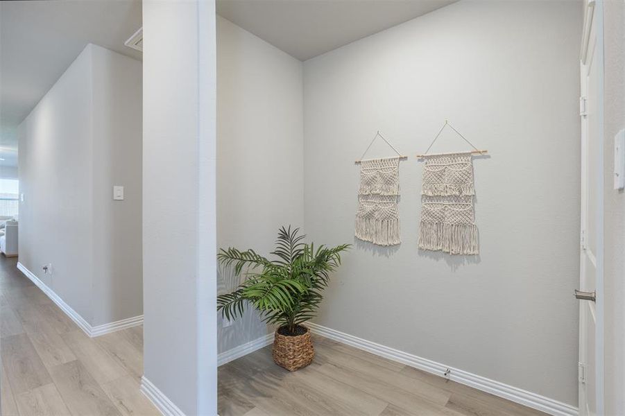 Hallway featuring light wood-type flooring and baseboards Hallway featuring light wood-type flooring and baseboards