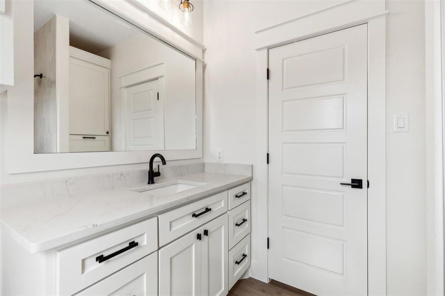 Bathroom featuring vanity and wood-type flooring