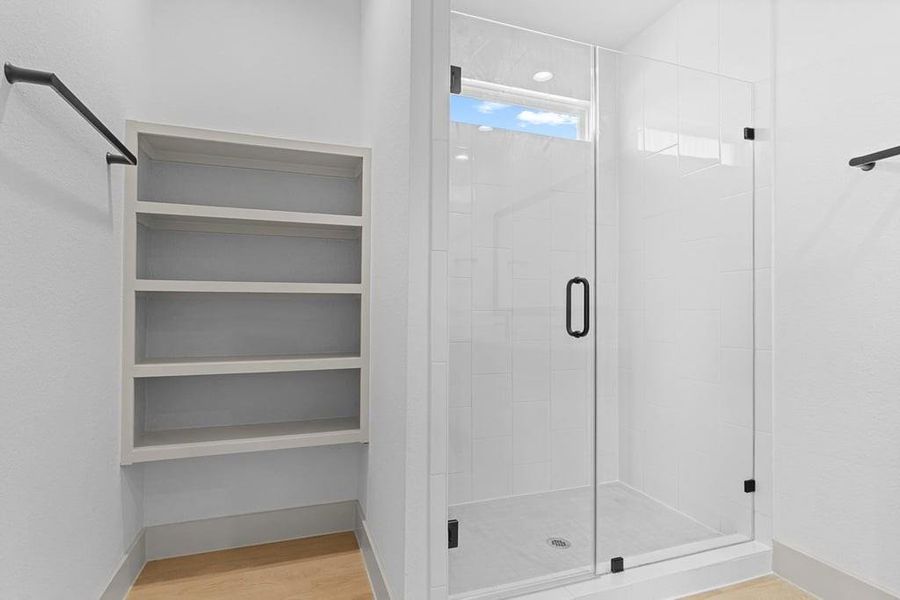 Primary bathroom with a glass-enclosed standing shower Primary bathroom with a glass-enclosed standing shower